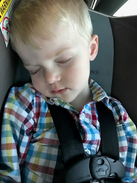 Toddler sleeping in his car seat 