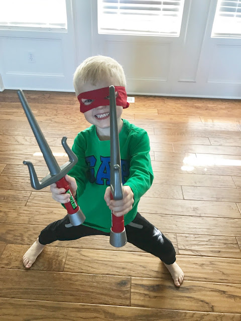 Little boy dressed up as Ninja Turtle 
