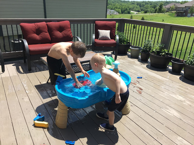 Brothers playing with water table 