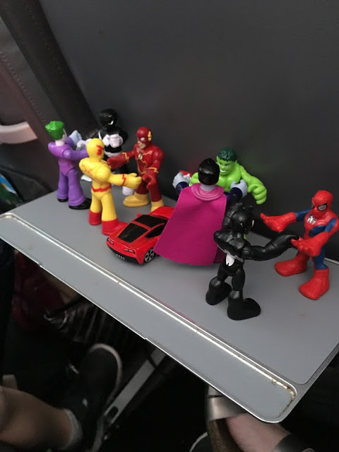 Superhero figures on airplane