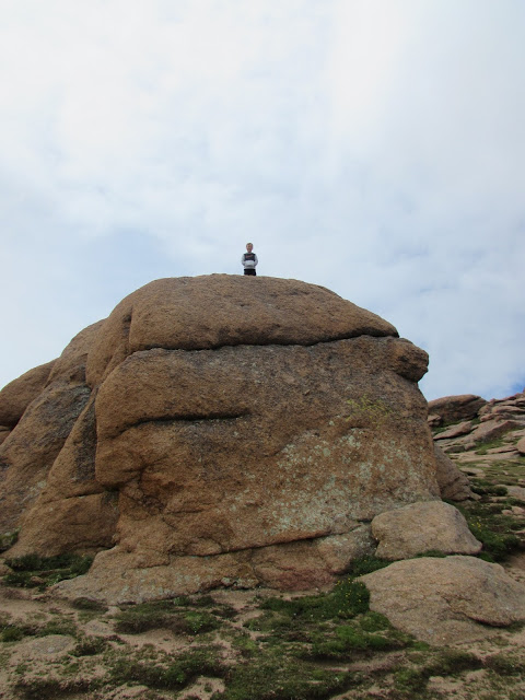 kid standing on high rock Pike's Peak 