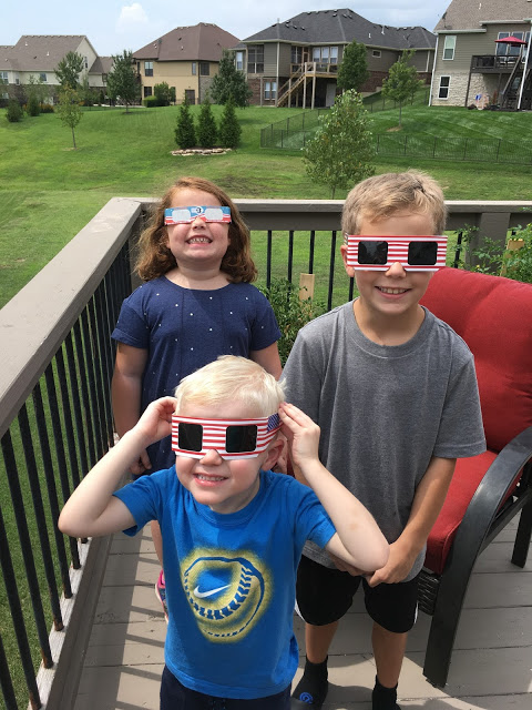 Kids wearing solar eclipse glasses