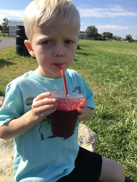 Boy drinking smoothie farmer's market 