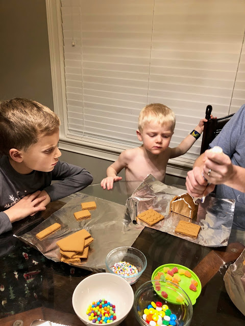 December Recap: Dad and sons building gingerbread houses 