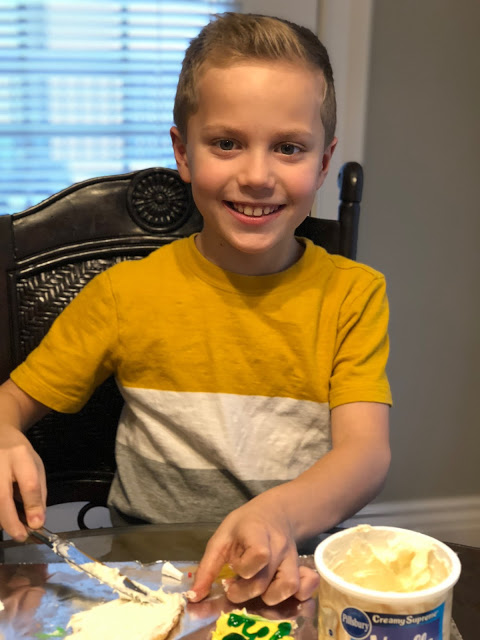 Little boy decorating Christmas cookies 