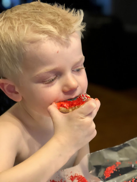 Little boy eating Christmas cookie