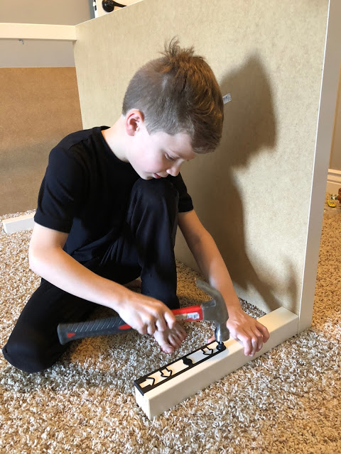 8 year old boy assembling Ikea table