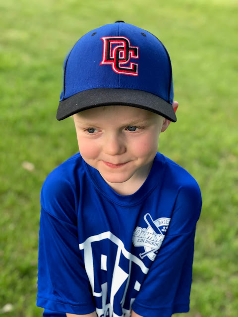 5 year old wearing t-ball hat