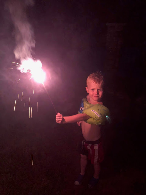 Young boy holding a sparkler 