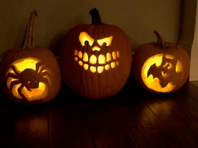 Carved pumpkins with candles glowing  