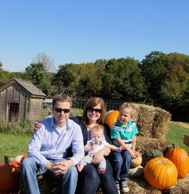 Family with a baby and toddler at the pumpkin patch 