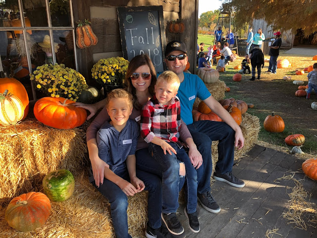 Family of four at pumpkin patch 