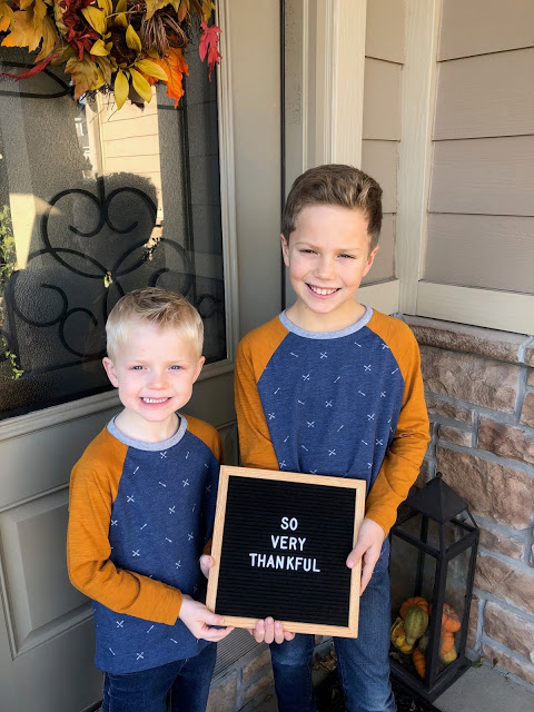 Young brothers holding So Very Thankful felt letter board 
