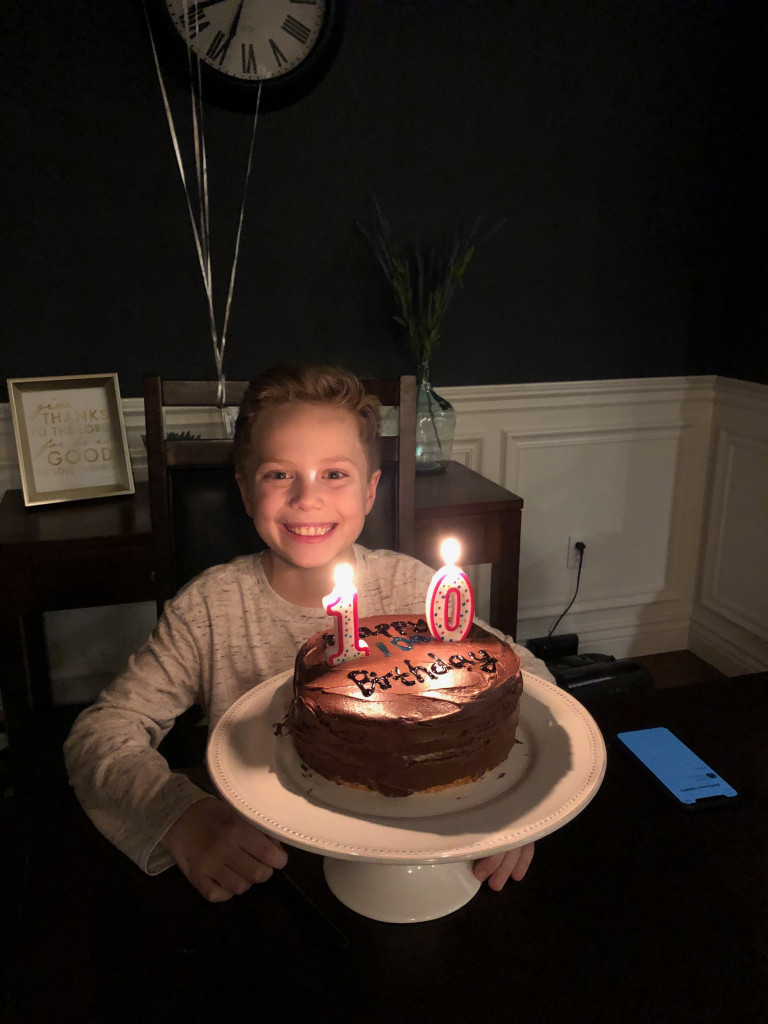 Boy with 10th birthday cake 