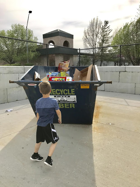 Boy recycling cardboard 