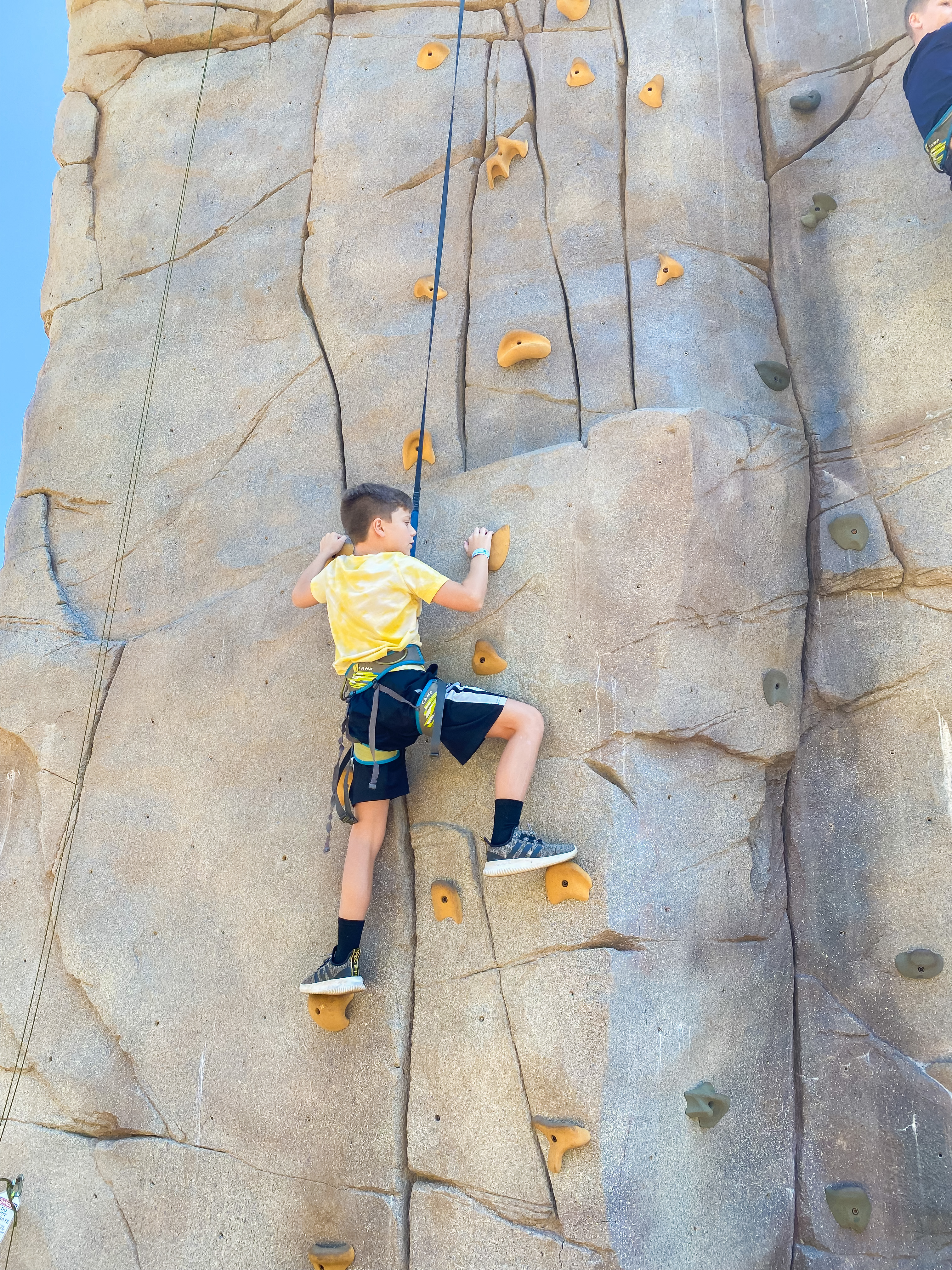Boy rock climbing Epic Discovery 